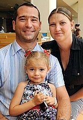 US Navy Lt. Cmdr. Jean Dupin De Saint Cyr ('95) with daughter Isabelle, and wife Anet 